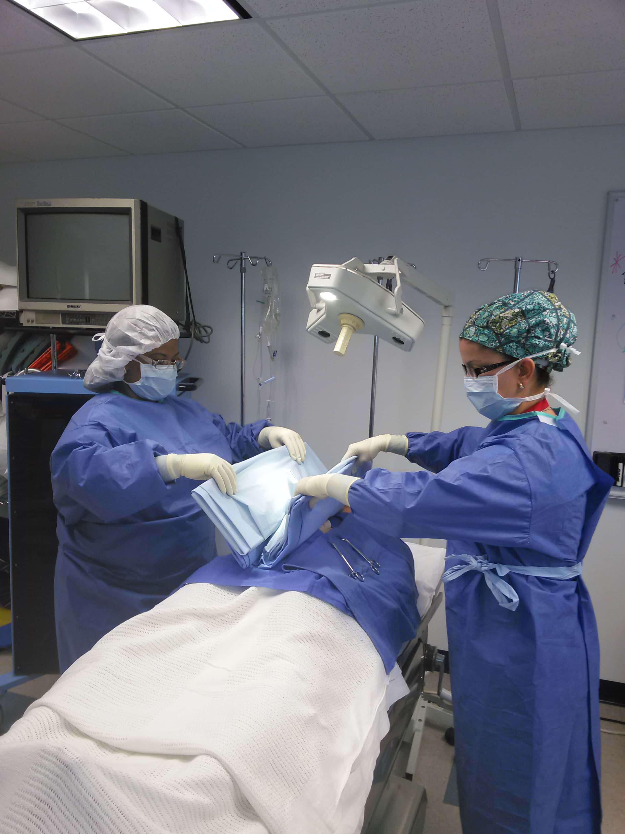 Keiser University Clearwater Surgical Technology Students Practice Draping a Patient for Surgery