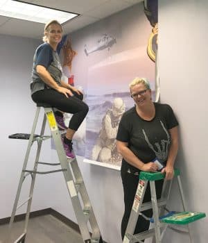 Dr Pamela Mertens And Kerri Percy Install The Mural A 9 14 19 - Keiser University's West Palm Beach Campus Unveils Veterans Resource Center - Seahawk Nation