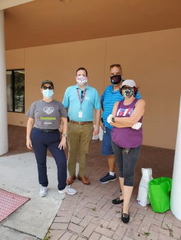 volunteers wearing masks at drive-thru food distribution event