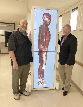 Keiser University faculty member Scott Sachs and Dept. Chair Shawn McPartland with the Anatomage device