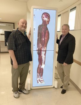 Keiser University Faculty Member Scott Sachs And Dept Chair Shawn Mcpartland With The Anatomage Device - Biomedical Science Tool Jumpstarts Anatomical Examinations - Academics Keiser University faculty member Scott Sachs and Dept. Chair Shawn McPartland with the Anatomage device