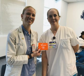 Keiser University Nursing Instructor Allyson Swan was administered her booster shot by student Tabitha Weber.