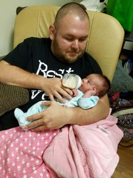 Keiser University Graduate Justin Rhodes Feeds His Daughter Kaydence After Recovering From A Near Fatal Motorcycle Accident - Occupational Therapy Graduate Looks Forward To Helping Others After A Near-fatal Motorcycle Accident - Graduate Spotlight