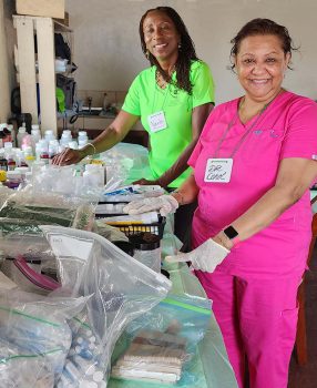 Keiser University Nursing Professor Dr Carol Phim Right Is Joined By Pharmacist Veola Alleyne - In Aftermath Of Volcano Eruption, Keiser University Nursing Faculty Members Offer Breath Of Fresh Air - Community News