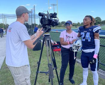 Ku Football Mom Robin Age Center And Her Son Cj Gilmore Right Are Interviewed By Cade Tjomsland Of Espn - Breast Cancer Awareness: Seahawk Football Players Recognize Breast Cancer Survivors As Honorary Team Captains - Keiser University Flagship