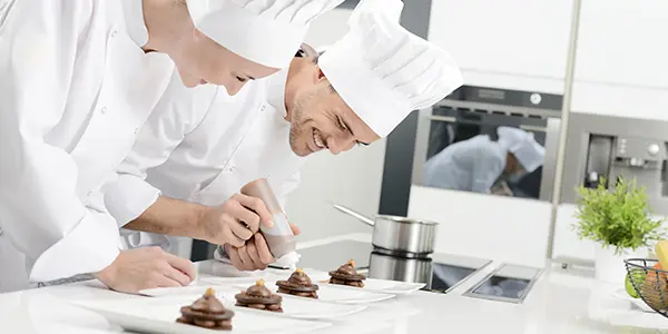 Baking and pastry arts student creating desserts and practicing professional baking techniques