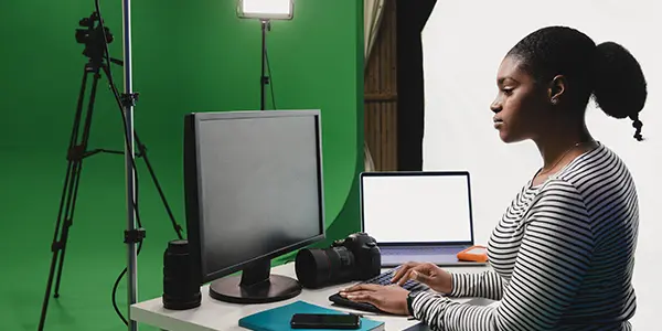 Cinematic arts BA student filming a scene using camera and production equipment