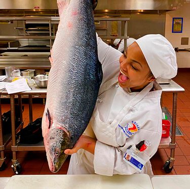 Keiser Culinary Grad Jada Vidal holding a fish