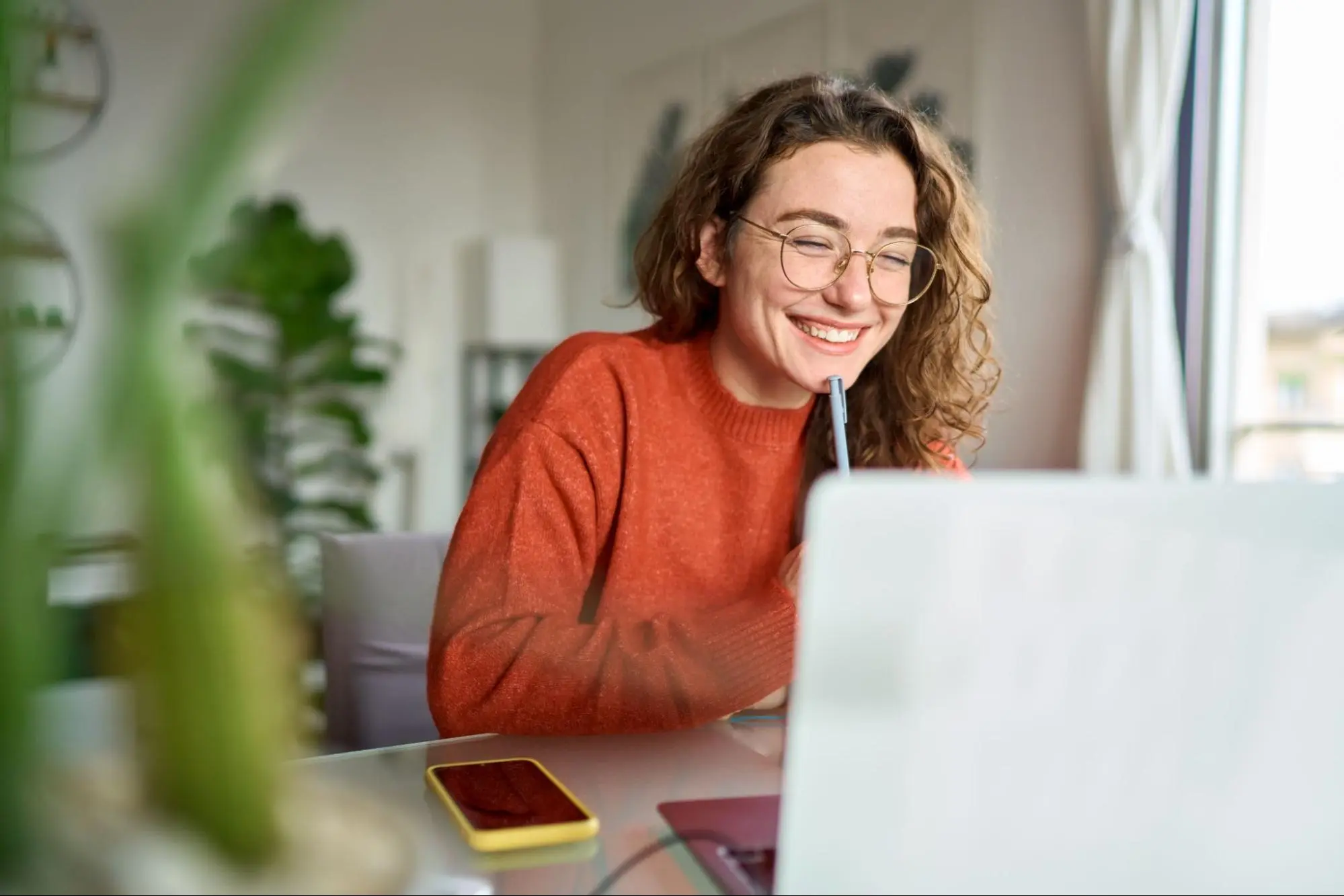 Online sports management student attending a virtual class on a laptop