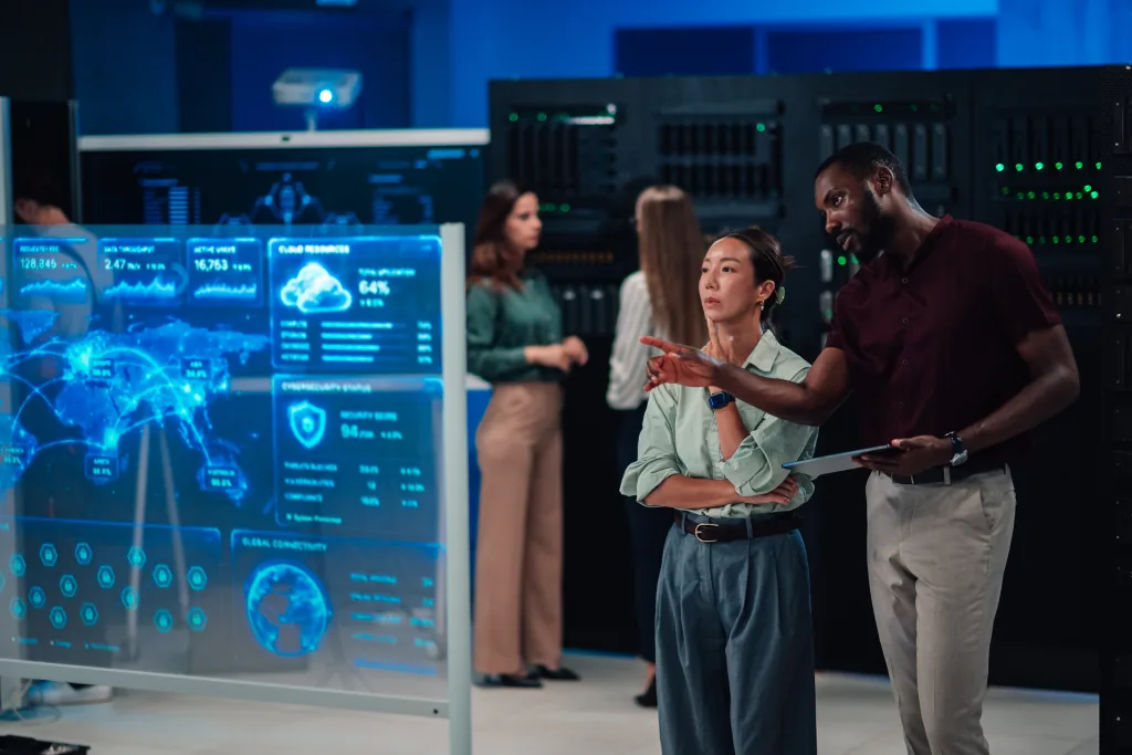 Cybersecurity professionals reviewing a security dashboard in a server room
