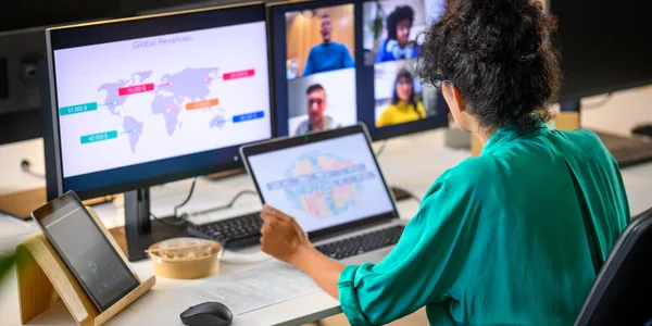 Professional reviewing a world map presentation during a video call with international colleagues